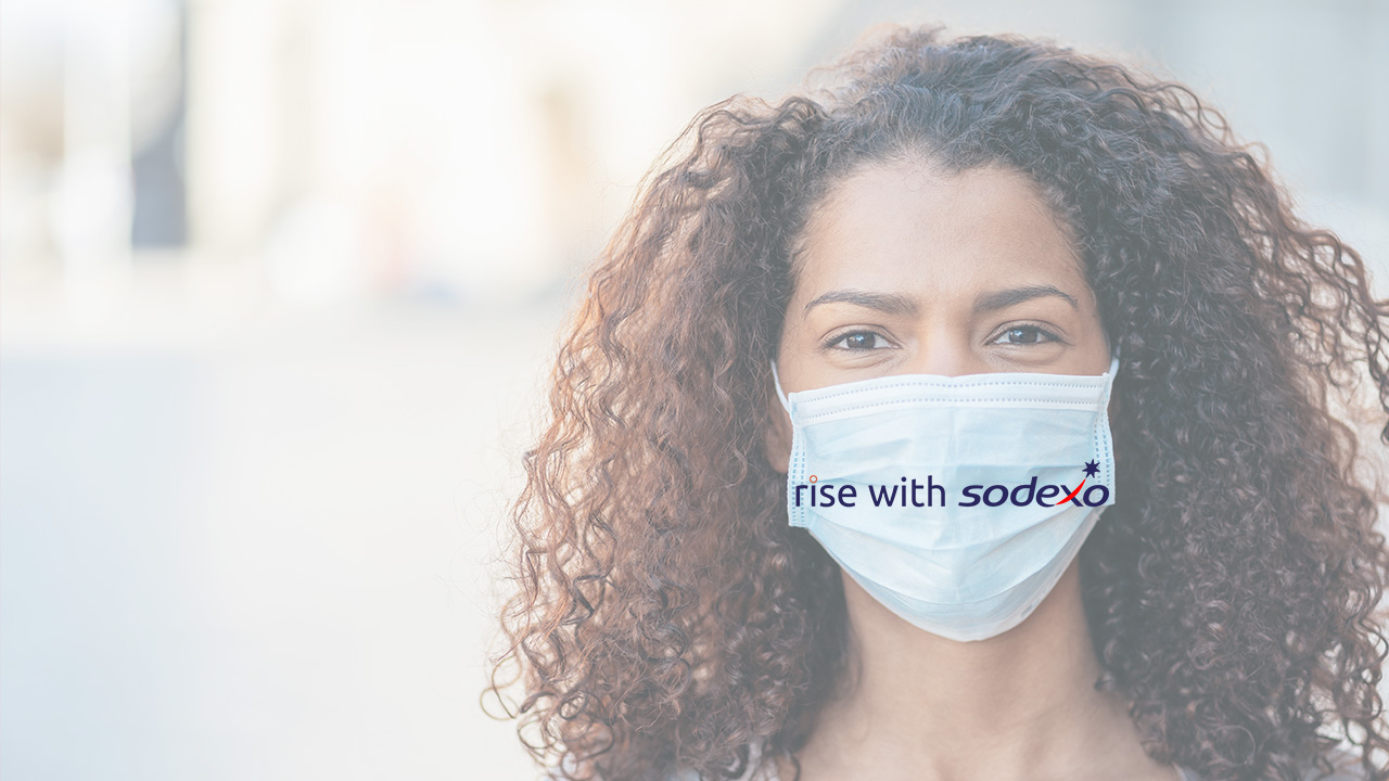 woman wares mask with text rise-with-sodexo