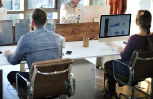 Two people working on desktop computers