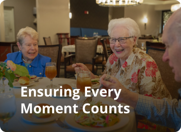 Group of people enjoying dinner. Text over image says: ensuring every moment counts