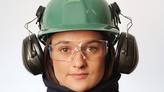 An offshore employee with a helmet, glasses and ear protection