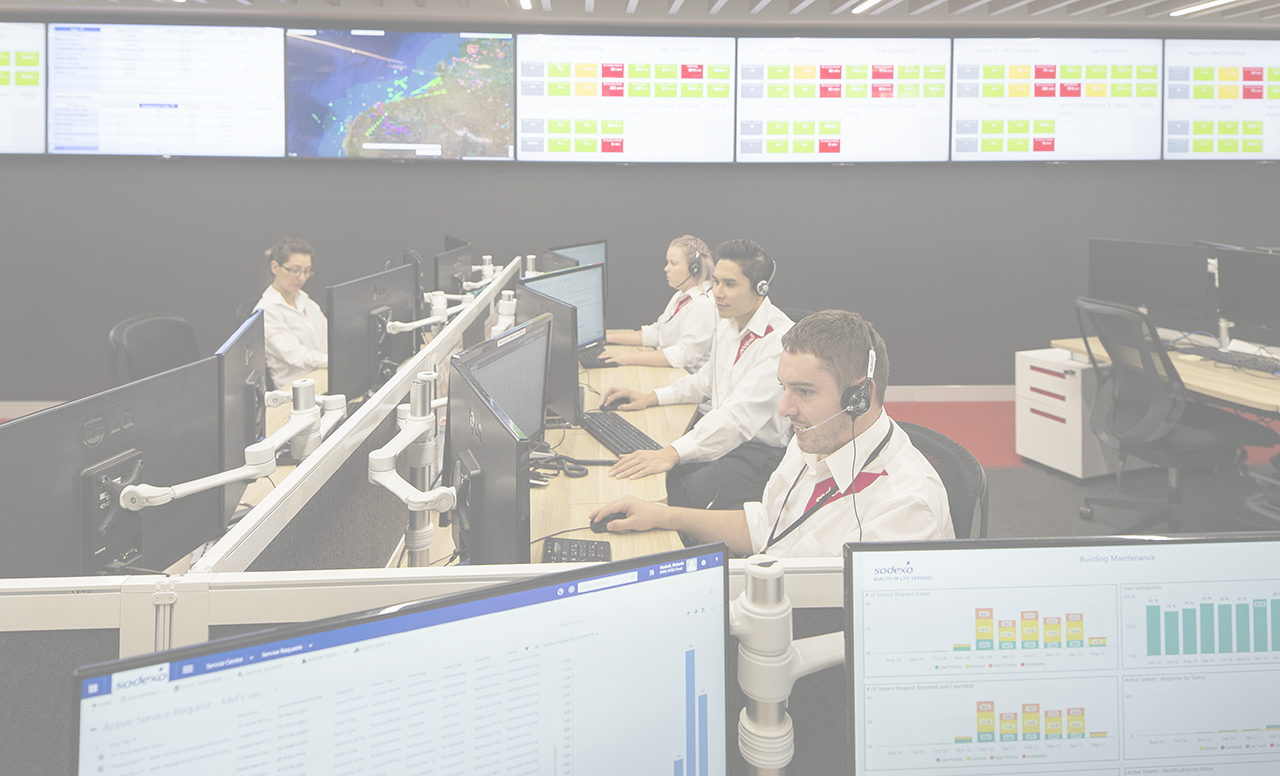 Sodexo employees in a call center with screens in the background